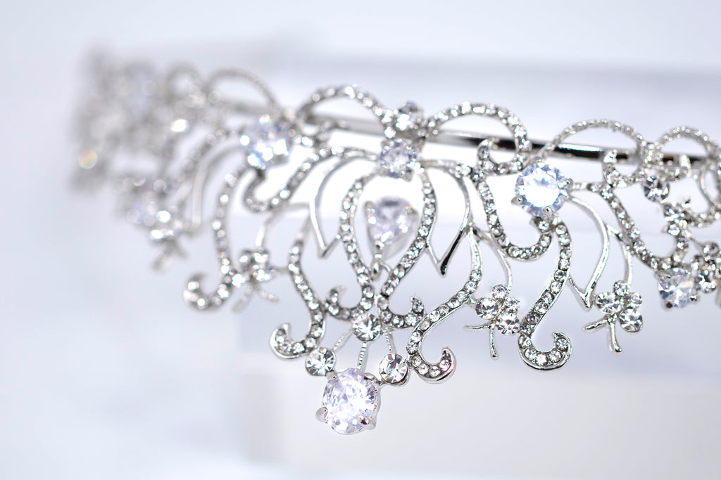 A close-up view of a sparkling tiara or crown adorned with numerous sparkling diamonds.