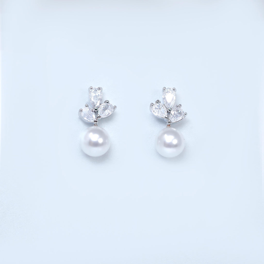 A pair of elegant earrings with a pearl and a crystal embellishment.
