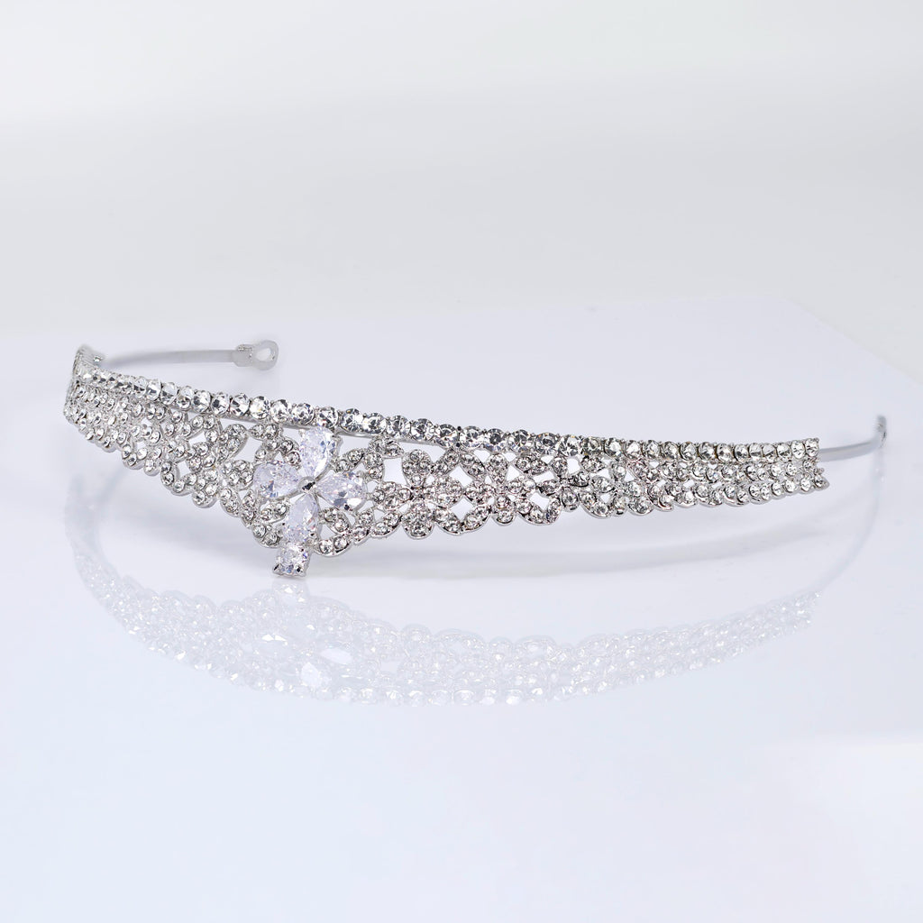 A silver tiara adorned with numerous sparkling rhinestones.