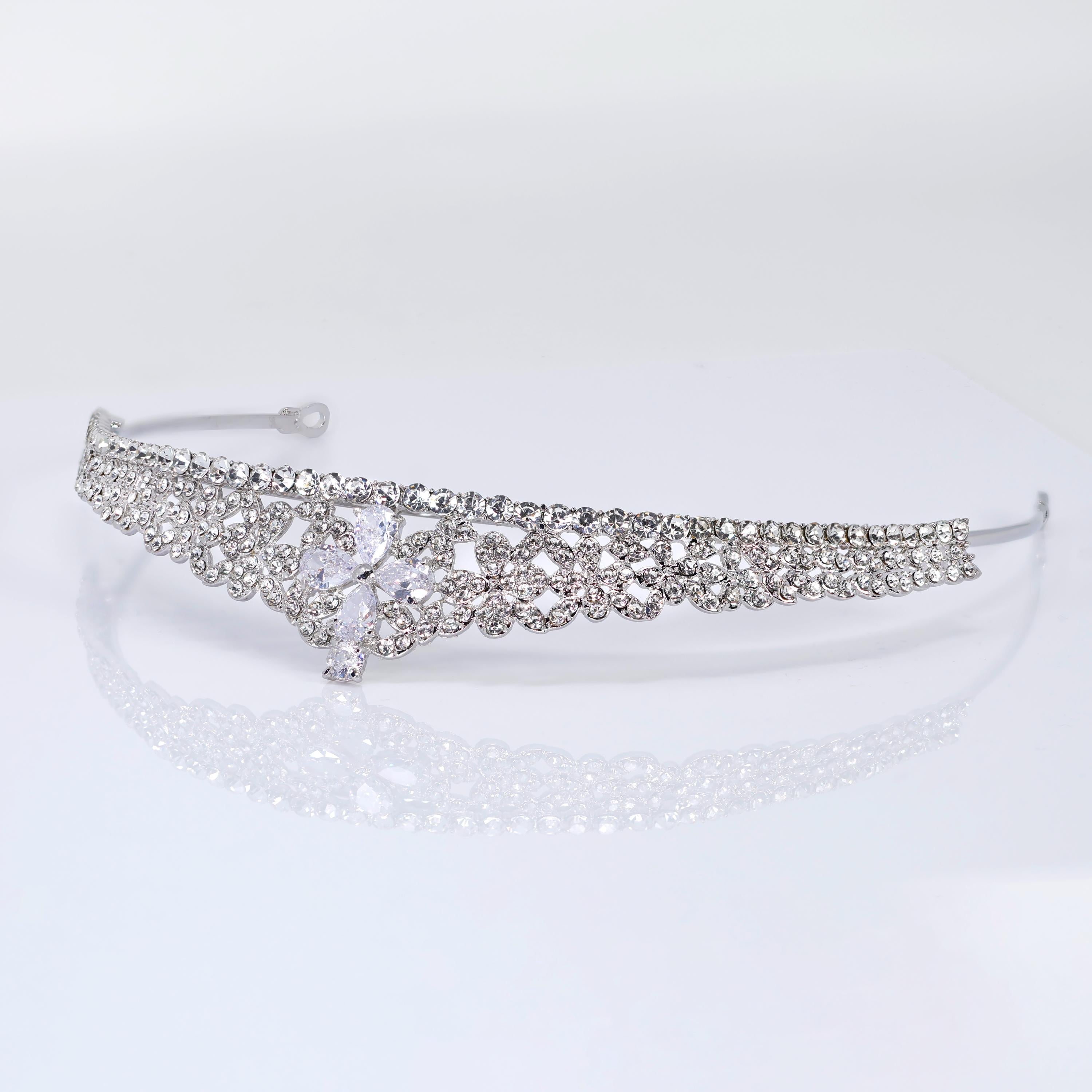 A silver tiara adorned with numerous sparkling rhinestones.